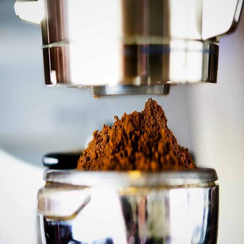 grind espresso beans in a coffee grinder