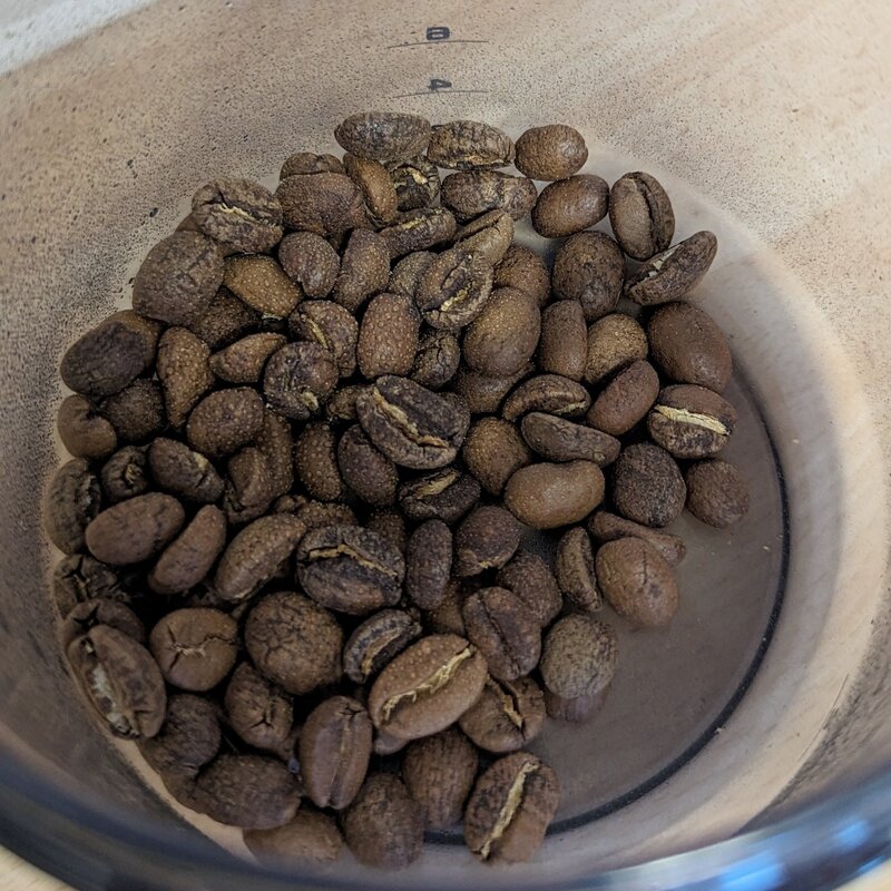 grind espresso beans in a coffee grinder